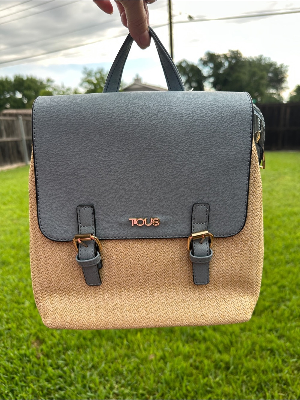 TOUS Blue-Gray Flap Straw Backpack with Gold Accents “Not an Original”.